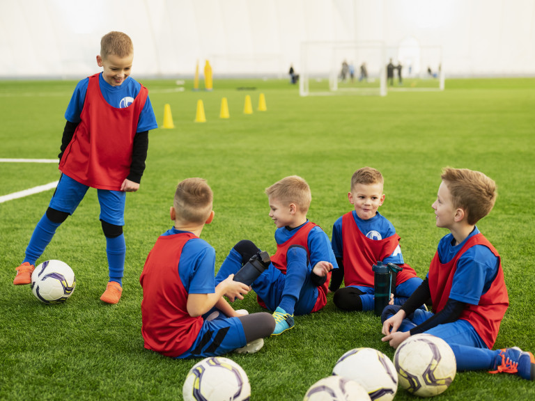 full-shot-kids-sitting-field-2